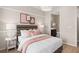 A serene bedroom featuring neutral tones, stylish decor, and a peek into the ensuite bathroom at 1302 Nestled Valley Rd, Minneola, FL 34715