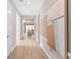 Inviting hallway with light hardwood floors and serene view into the living room and backyard at 1302 Nestled Valley Rd, Minneola, FL 34715