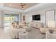 Bright living room featuring comfortable seating, a ceiling fan, stylish decor, and sliding glass doors at 1302 Nestled Valley Rd, Minneola, FL 34715