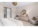 This bedroom offers a calming atmosphere with a decorative wicker lamp shade and a neutral color palette at 1302 Nestled Valley Rd, Minneola, FL 34715