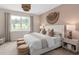 Serene bedroom with a plush bed, stylish decor, and a large window offering a peaceful view at 1302 Nestled Valley Rd, Minneola, FL 34715