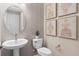 Stylish powder room featuring elegant fixtures, attractive wallpaper, and modern decor at 1302 Nestled Valley Rd, Minneola, FL 34715