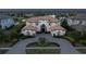 Expansive aerial view featuring an impressive home, manicured landscaping, and circular driveway at 13125 Casabella Dr, Windermere, FL 34786