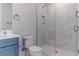 Bright bathroom featuring a glass shower with white marble-look tiles and modern fixtures at 13125 Casabella Dr, Windermere, FL 34786