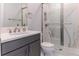 Bathroom showcasing a glass shower with mosaic accents and modern gray cabinetry at 13125 Casabella Dr, Windermere, FL 34786