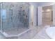 Spa-like bathroom showcases a frameless glass shower with built-in shelving and modern fixtures at 13125 Casabella Dr, Windermere, FL 34786