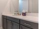 Bathroom featuring a large vanity with gray cabinets and a modern faucet at 13125 Casabella Dr, Windermere, FL 34786