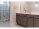 Modern bathroom featuring dual sink vanity and tiled walk-in shower with glass door at 13125 Casabella Dr, Windermere, FL 34786