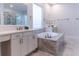 Elegant bathroom featuring double vanities, marble counters, and a soaking tub at 13125 Casabella Dr, Windermere, FL 34786