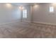 Light-filled bedroom showcasing neutral carpet, white walls, baseboards, and plantation shutters at 13125 Casabella Dr, Windermere, FL 34786