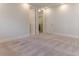 Bright bedroom featuring neutral carpet, white walls, baseboards, and a walk-in closet at 13125 Casabella Dr, Windermere, FL 34786