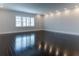 Bright bedroom featuring hardwood floors, white walls, and plantation shutters at 13125 Casabella Dr, Windermere, FL 34786