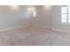 Bright bedroom featuring neutral carpet, white walls, baseboards, and plantation shutters at 13125 Casabella Dr, Windermere, FL 34786