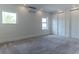 Spacious bedroom featuring neutral carpet, white walls, baseboards, and large windows at 13125 Casabella Dr, Windermere, FL 34786