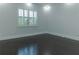 Bright bedroom featuring hardwood floors, fresh white paint, baseboards, and plantation shutters for natural light at 13125 Casabella Dr, Windermere, FL 34786