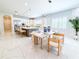 A dining area and kitchen combination with stainless steel appliances, a large island, and bar stool seating at 13125 Casabella Dr, Windermere, FL 34786