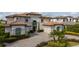 Attractive two-story home with well-maintained landscaping, a circular driveway, and an attached two-car garage at 13125 Casabella Dr, Windermere, FL 34786