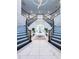 Bright foyer showcasing a grand double staircase, chandelier and elegant white tile floors at 13125 Casabella Dr, Windermere, FL 34786