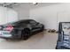 Clean garage with neutral floor, a parking bumper, and an eye-catching black sports car at 13125 Casabella Dr, Windermere, FL 34786