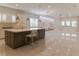 Bright kitchen with island, stainless steel appliances, pendant lighting, and open floor plan at 13125 Casabella Dr, Windermere, FL 34786