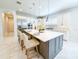 Elegant kitchen with white cabinets, stainless steel appliances, and a large island with bar seating at 13125 Casabella Dr, Windermere, FL 34786