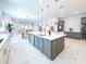 Spacious kitchen featuring a large central island, stainless steel appliances, and modern cabinetry for ample storage at 13125 Casabella Dr, Windermere, FL 34786