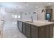 Modern kitchen with a large island, stainless steel appliances, and stylish pendant lighting at 13125 Casabella Dr, Windermere, FL 34786