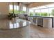 Elegant outdoor kitchen boasts stainless steel appliances, stone countertops, and a pizza oven for delightful outdoor dining at 13125 Casabella Dr, Windermere, FL 34786
