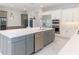 Gourmet kitchen featuring a large island, stainless steel appliances, and wine storage at 13125 Casabella Dr, Windermere, FL 34786