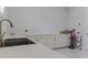 Bright laundry room with modern sink and lots of storage in the white cabinetry and marble tile flooring at 13125 Casabella Dr, Windermere, FL 34786