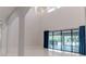Bright and airy living room with high ceilings, marble floors, modern light fixture, and large sliding glass doors at 13125 Casabella Dr, Windermere, FL 34786