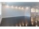 Spacious living room with dark hardwood floors, white walls and bright recessed lighting at 13125 Casabella Dr, Windermere, FL 34786