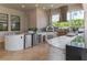 Outdoor kitchen featuring a pizza oven, grill, tiled countertops, and beverage refrigerators at 13125 Casabella Dr, Windermere, FL 34786