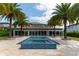 Backyard view of a pool with a spa, lined with palm trees and overlooking the main house at 13125 Casabella Dr, Windermere, FL 34786
