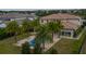 An aerial view of the backyard of a luxury home, featuring a blue pool, spa, and manicured lawn at 13125 Casabella Dr, Windermere, FL 34786