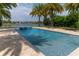 Backyard with a large pool, spa, mature landscaping, and neighborhood views at 13125 Casabella Dr, Windermere, FL 34786