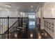 Open upstairs hallway featuring hardwood floors, decorative iron railings, and a decorative chandelier at 13125 Casabella Dr, Windermere, FL 34786