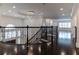 Upstairs hallway featuring decorative iron railings, hardwood floors, and a decorative chandelier at 13125 Casabella Dr, Windermere, FL 34786
