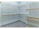 Spacious walk-in closet offers abundant storage with custom shelving and rod system at 13125 Casabella Dr, Windermere, FL 34786