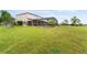 Spacious backyard featuring a screened-in lanai, offering privacy and stunning views at 13640 Dornoch Dr, Orlando, FL 32828