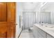 Bathroom featuring double sinks, neutral tones, and a shower curtain for a clean and functional space at 13640 Dornoch Dr, Orlando, FL 32828