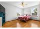 Cozy bedroom with hardwood floors, ceiling fan, and ample natural light creating a welcoming atmosphere at 13640 Dornoch Dr, Orlando, FL 32828