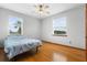 Bright bedroom features hardwood floors, ceiling fan, and natural light, creating a serene retreat at 13640 Dornoch Dr, Orlando, FL 32828