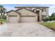 Charming two-story home with a spacious driveway, brick accents, and well-maintained landscaping at 13640 Dornoch Dr, Orlando, FL 32828