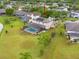 Aerial view of a home with a screened pool, big lawn, and beautiful landscaping at 13640 Dornoch Dr, Orlando, FL 32828