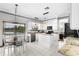 Modern kitchen with white cabinets, granite countertops, stainless steel appliances, and an island at 13640 Dornoch Dr, Orlando, FL 32828