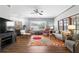 Cozy living room featuring a fireplace, large windows, and vibrant area rug, creating a warm atmosphere at 13640 Dornoch Dr, Orlando, FL 32828