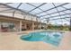 Inviting screened-in pool area with ample seating and a relaxing spa, perfect for outdoor entertaining at 13640 Dornoch Dr, Orlando, FL 32828