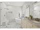 Stunning bathroom features marble walls, a sleek soaking tub, a walk-in shower, and elegant double vanity at 14131 Paradise Tree Dr, Orlando, FL 32828