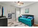 Compact bedroom with a daybed, soft lighting, and a minimalist decor, perfect for a cozy and stylish retreat at 14131 Paradise Tree Dr, Orlando, FL 32828